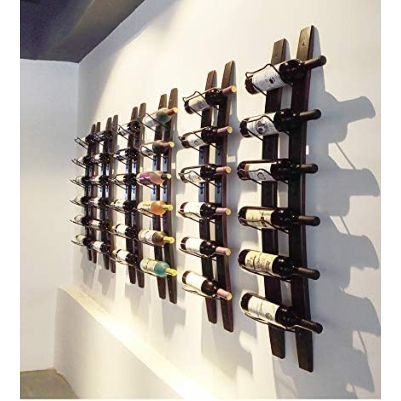 Wall-mounted wine rack display with multiple vertical wooden slats holding bottles